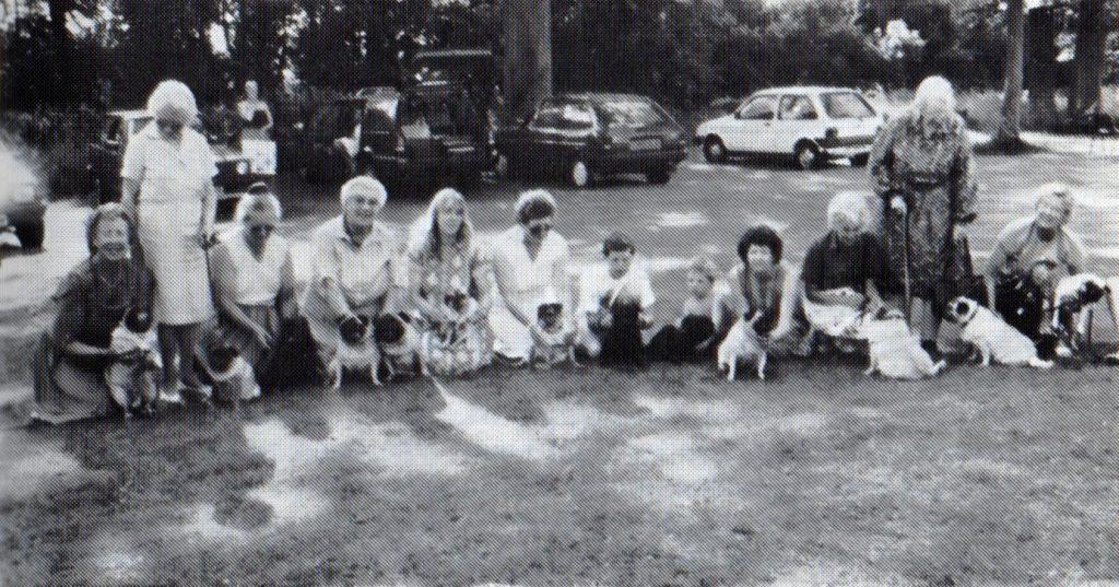 The photograph shows Mrs. Inge (with walking stick) at the 1987 Garden Party held at Crowhurst along with guests